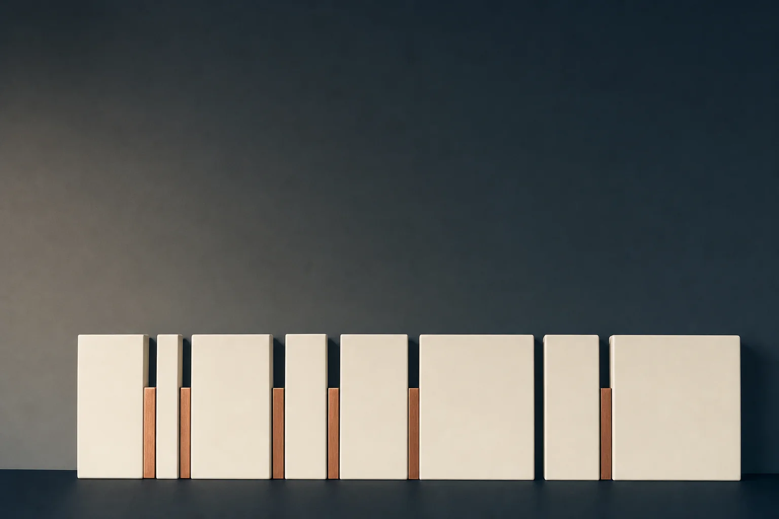 Plain ivory ceramic panels of different widths stand in a row against a navy wall, some pushed flush together and others parted by slim copper strips